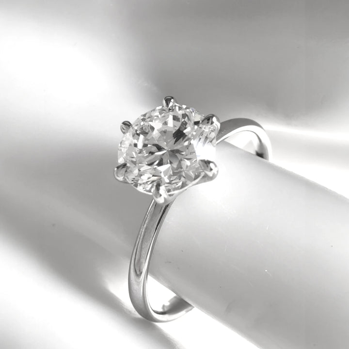 Elegant angled view of the diamond ring with soft lighting and high polish finish