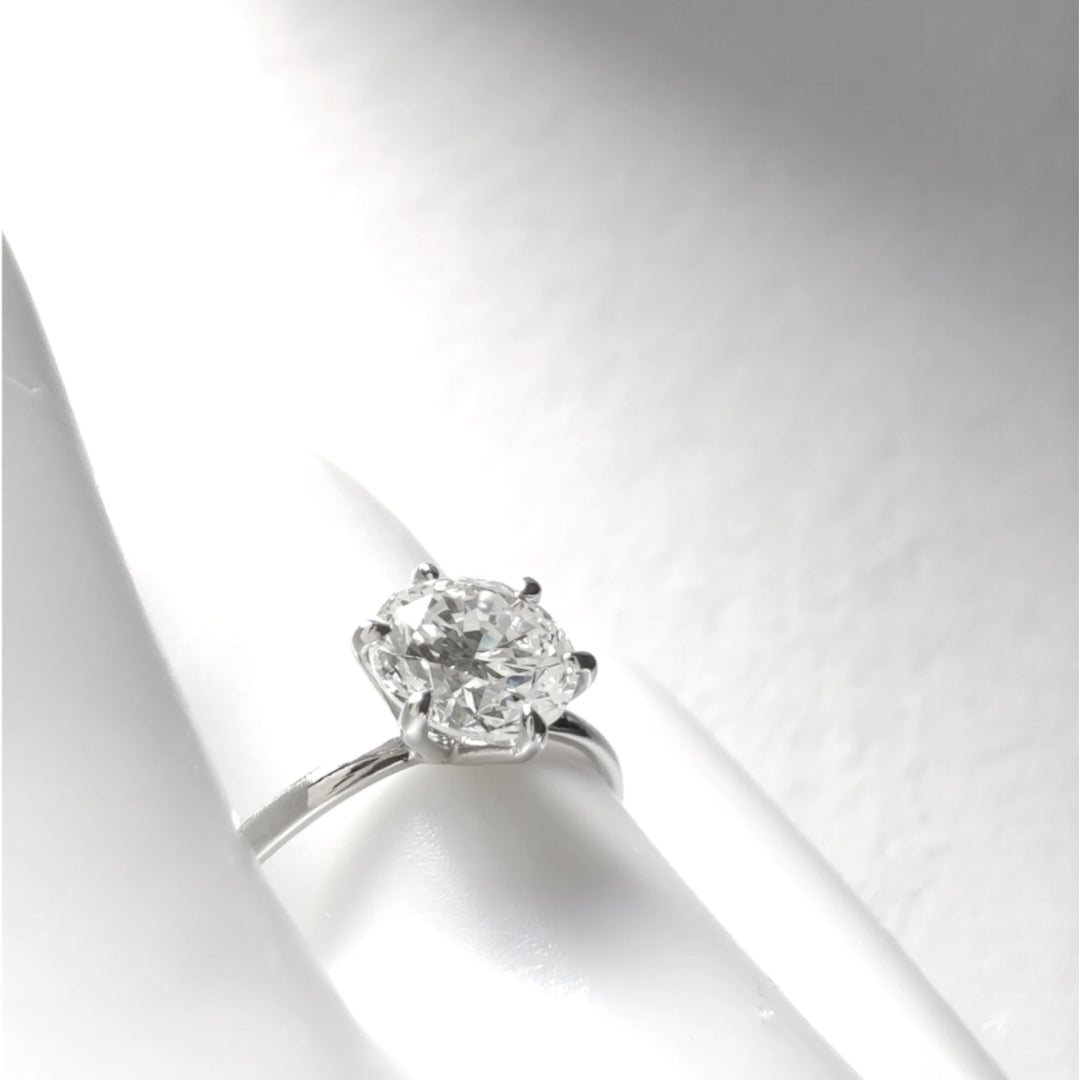 Diagonal artistic shot highlighting the sparkle and elevation of the diamond