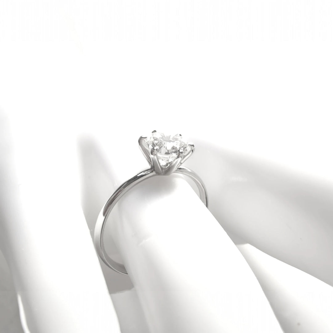Soft light photo focusing on white gold band and diamond mount from the side