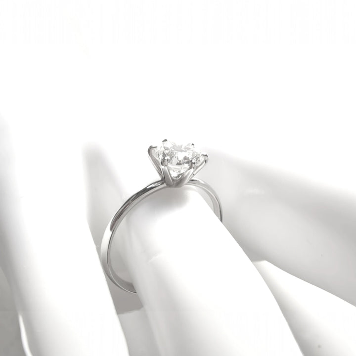 Soft light photo focusing on white gold band and diamond mount from the side
