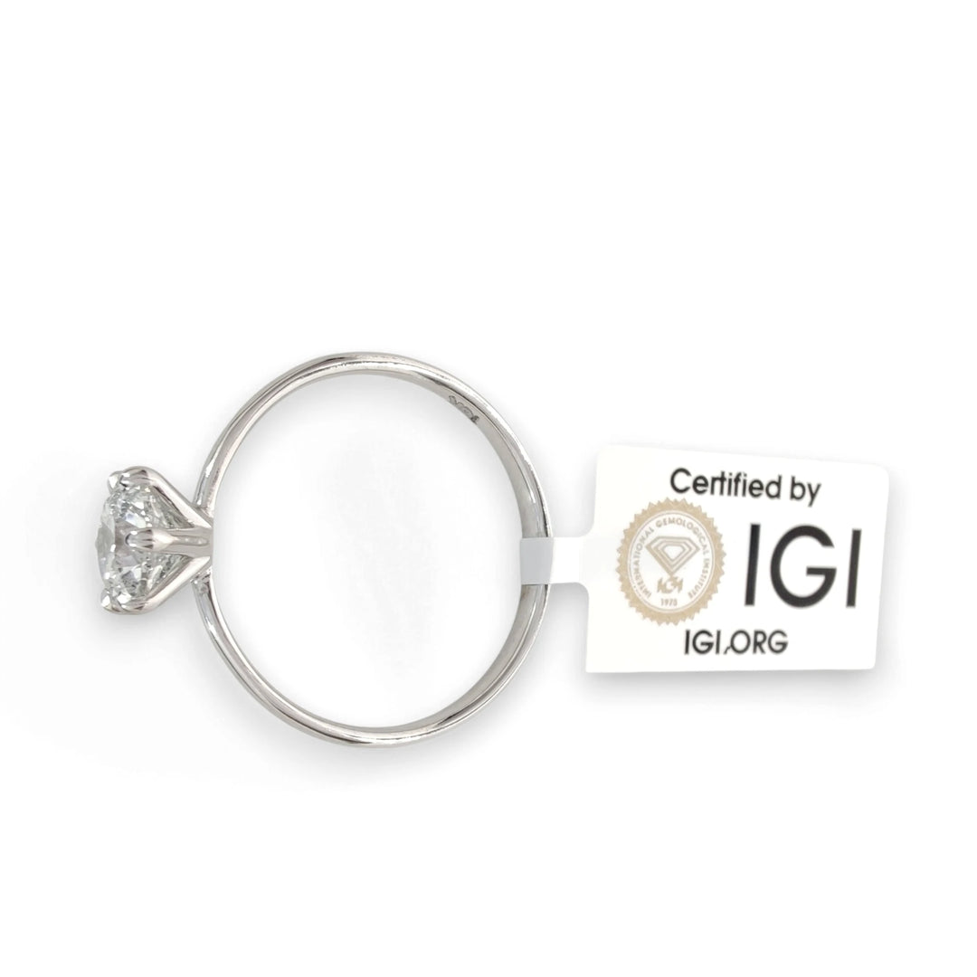 Top view of diamond engagement ring with IGI certification tag attached, 0.90 carat round brilliant cut