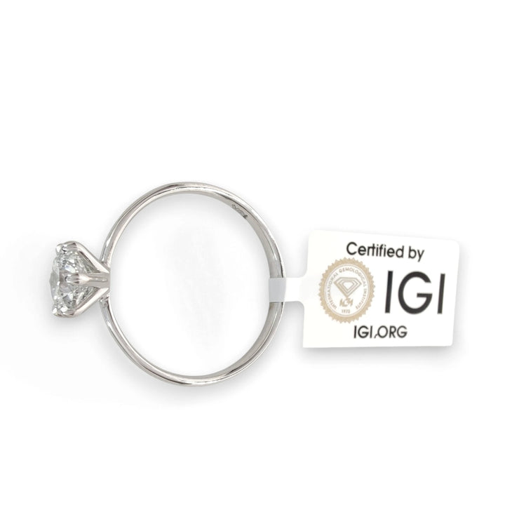 Top view of diamond engagement ring with IGI certification tag attached, 0.90 carat round brilliant cut