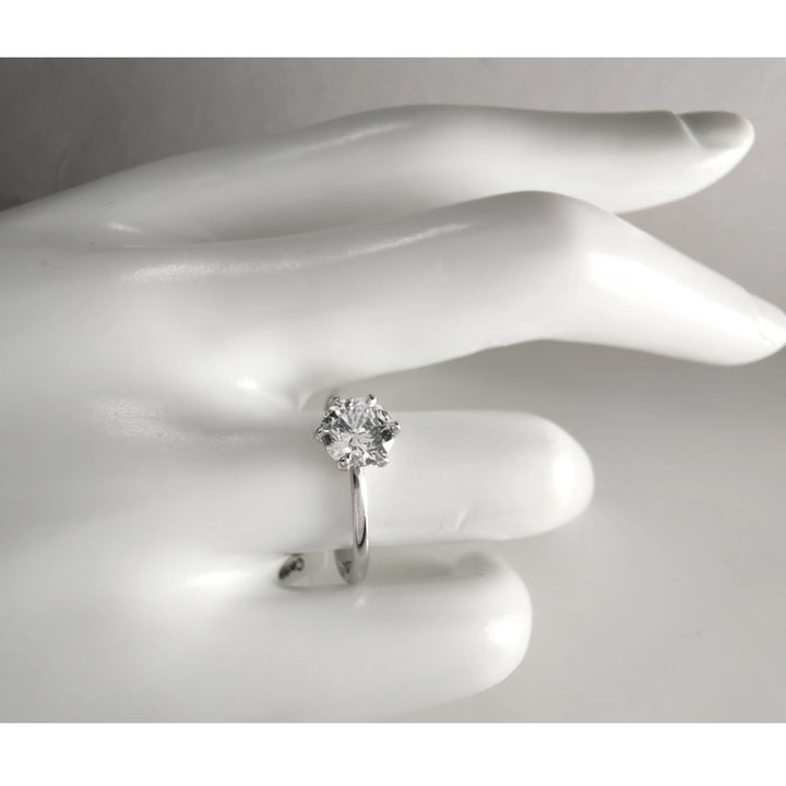 0.90ct diamond engagement ring worn on mannequin hand, showing six-prong setting and scale