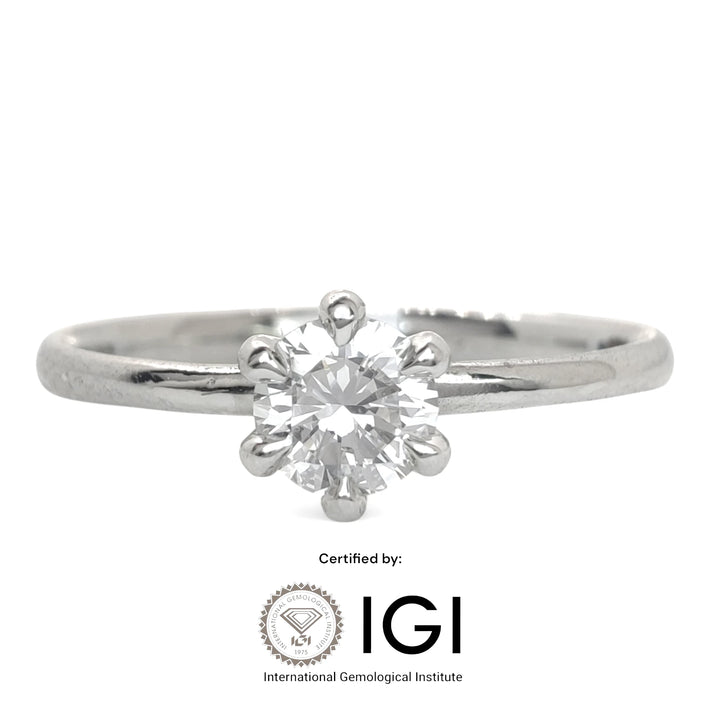 A classic six-prong solitaire engagement ring featuring a round brilliant-cut diamond set in polished platinum. The sleek band and secure prong setting highlight the stone’s brilliance against a minimalist white backdrop