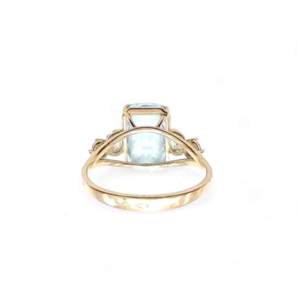 Back view of a 14K solid yellow gold ring with a central aquamarine and diamond details