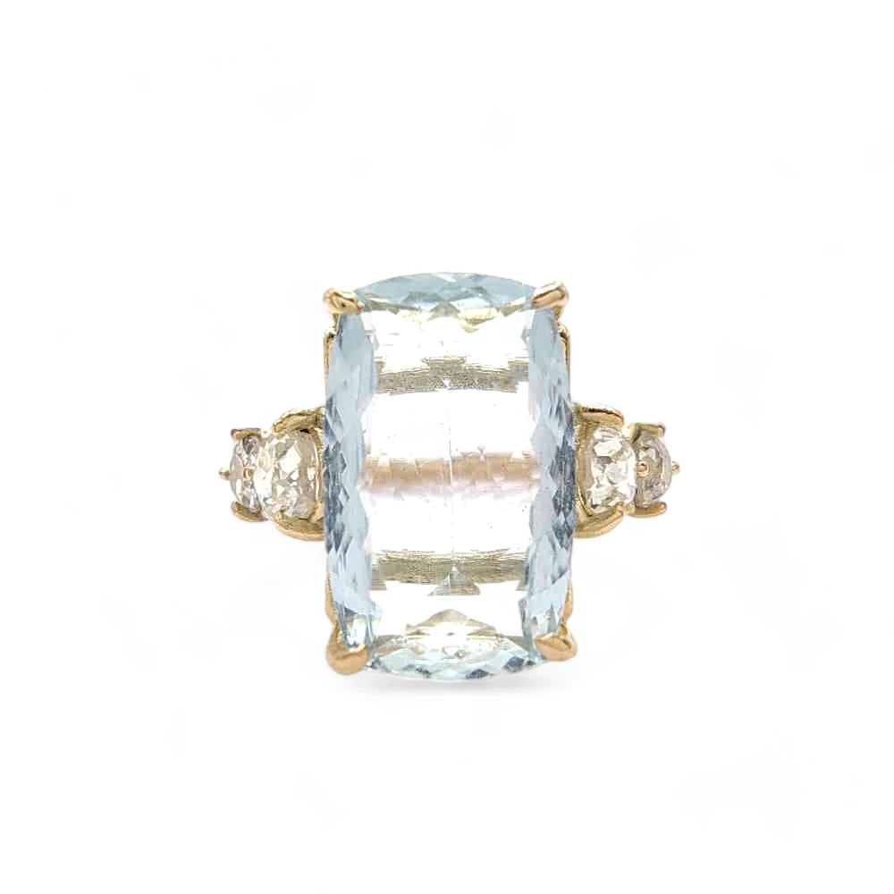 Front view of a 14K yellow gold ring with a central aquamarine and two brilliant-cut diamonds on each side