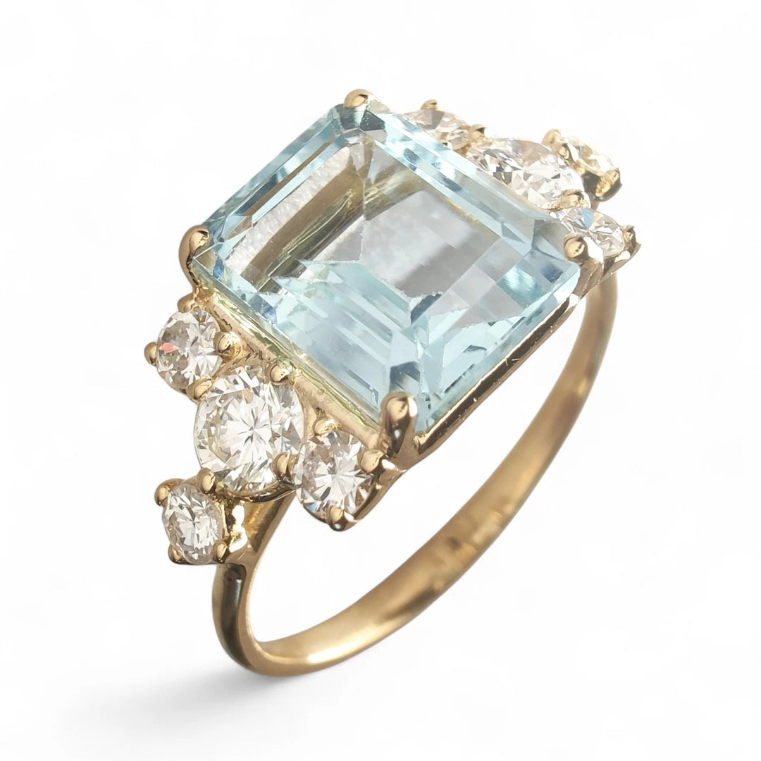 diamond ring 18k yellow gold	Close-up top view of aquamarine and diamond engagement ring in 18K yellow gold
