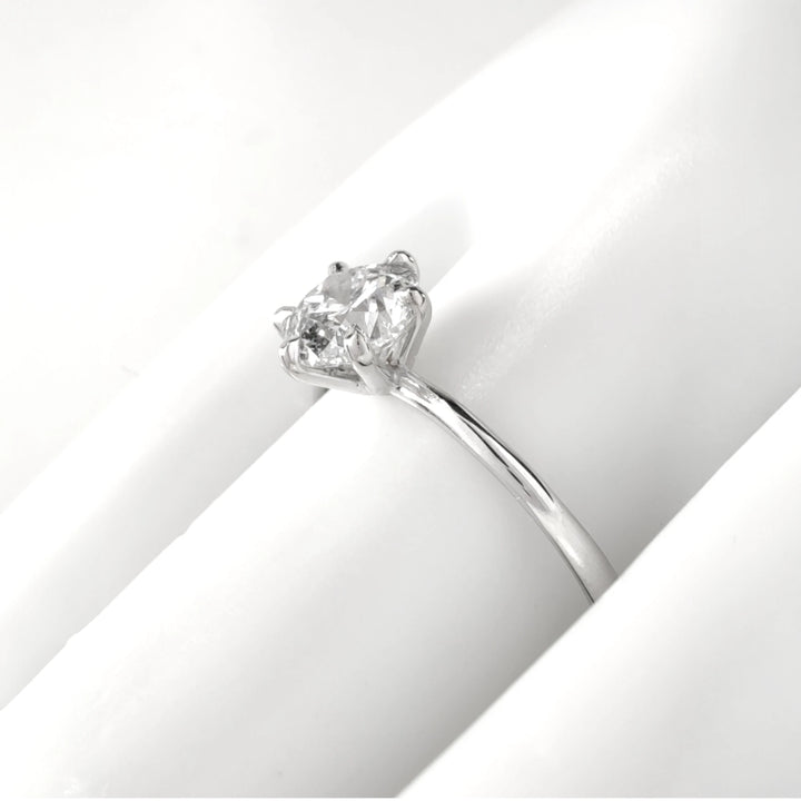 Close-up of diamond engagement ring on model's hand, showcasing elegance and everyday wearability