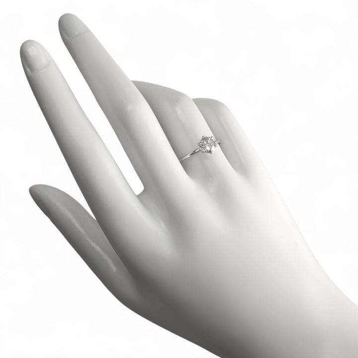 Macro shot of diamond ring highlighting six-prong setting detail and high-polish finish