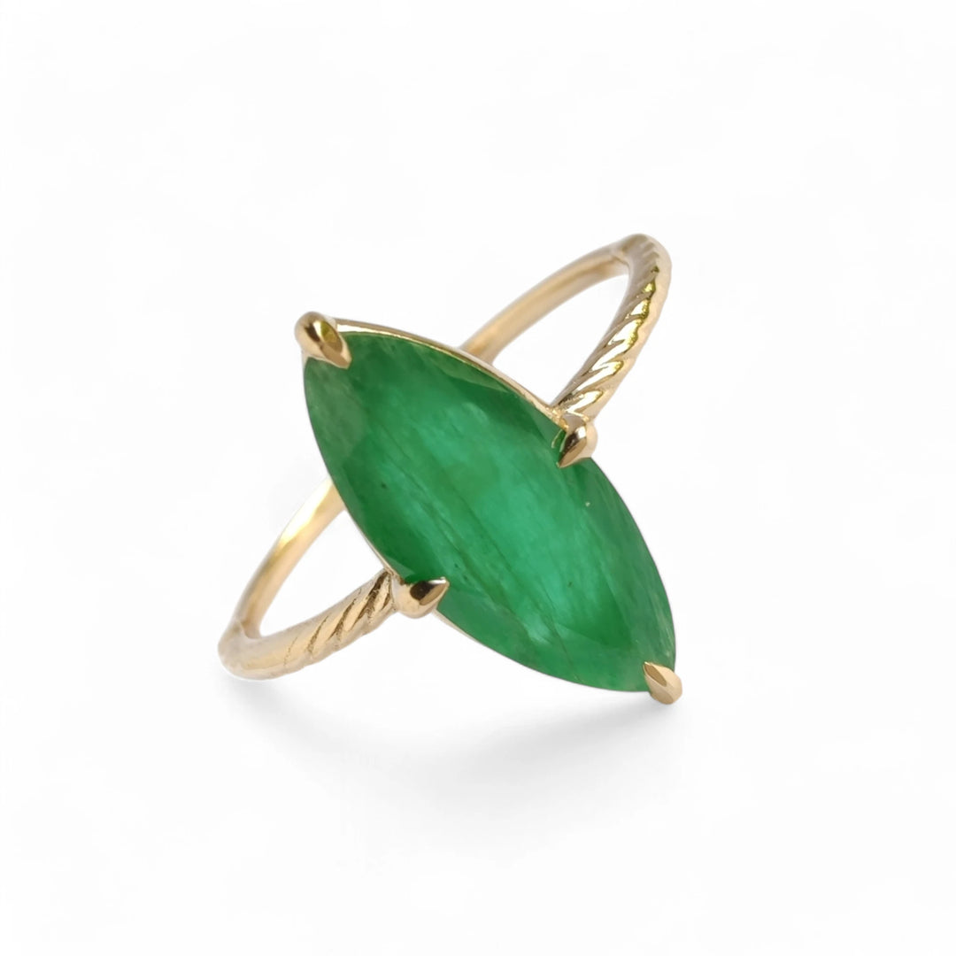 Vertical perspective view of a womenβs 18K yellow gold solitaire engagement ring with a marquise-cut emerald and vintage band design