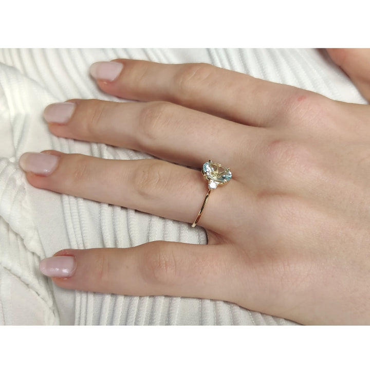 Chic 18K Gold Oval Aquamarine Ring Flanked by Diamonds