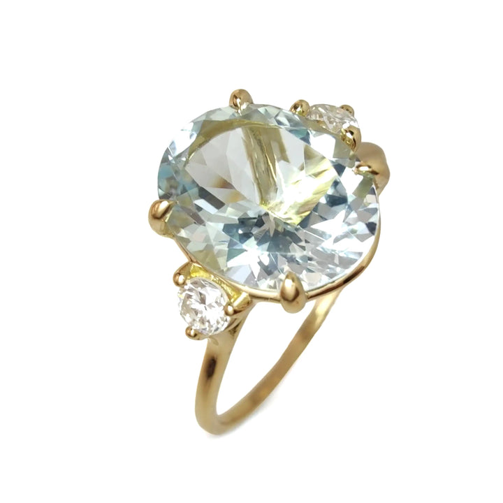 Chic 18K Gold Oval Aquamarine Ring Flanked by Diamonds