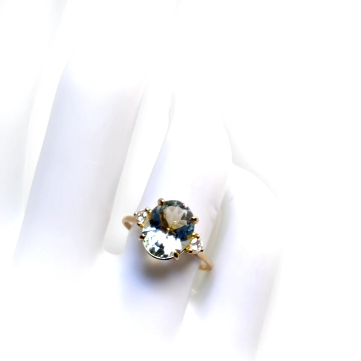 Chic 18K Gold Oval Aquamarine Ring Flanked by Diamonds