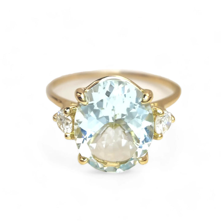 Chic 18K Gold Oval Aquamarine Ring Flanked by Diamonds