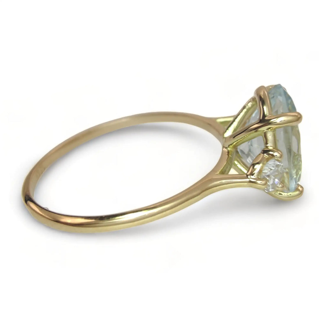 Chic 18K Gold Oval Aquamarine Ring Flanked by Diamonds