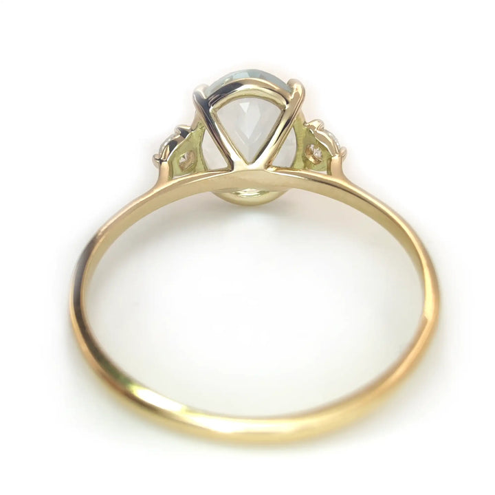 Chic 18K Gold Oval Aquamarine Ring Flanked by Diamonds