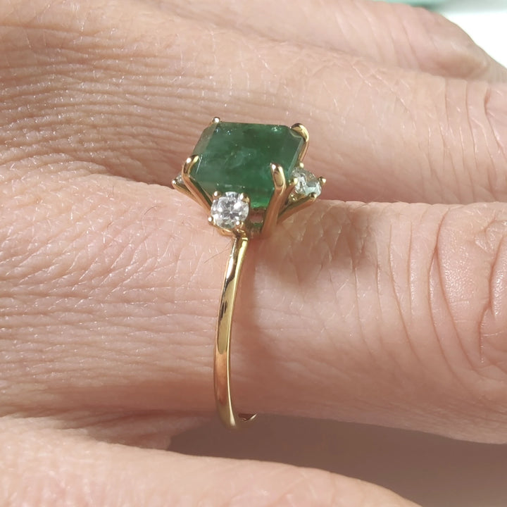 Close-up of the octagon emerald engagement ring, highlighting its green gemstone and brilliant diamonds for Christmas or engagements.