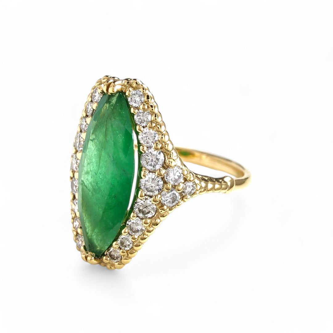 Yellow gold ring with an emerald and diamond halo setting