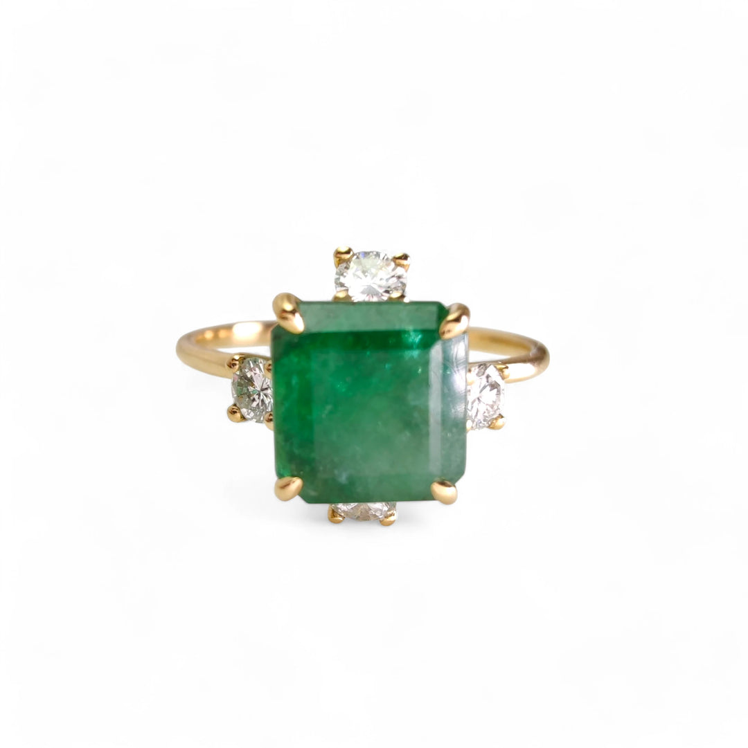 Frontal perspective of the 18K gold octagon emerald engagement ring with diamonds, ideal for engagements or holiday gifts