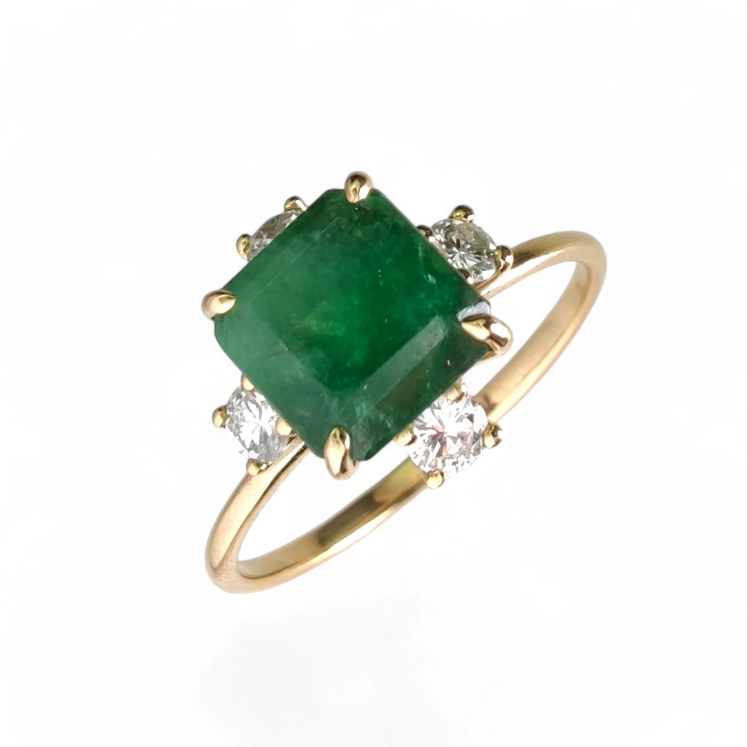 Perspective view of the 18K gold octagon emerald engagement ring with diamonds, offering timeless elegance for Christmas or engagements.