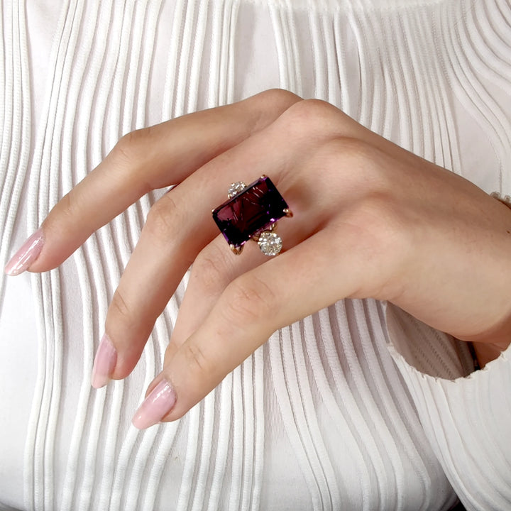 Stunning Amethyst and diamond three-stone ring in 14K yellow gold, shown on a model’s hand in a horizontal pose