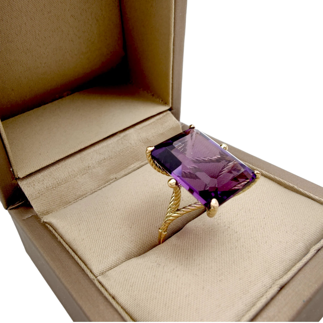 Exclusive 14K yellow gold ring with a large amethyst in a sculptural twisted prong setting, elegantly displayed in a jewelry gift box