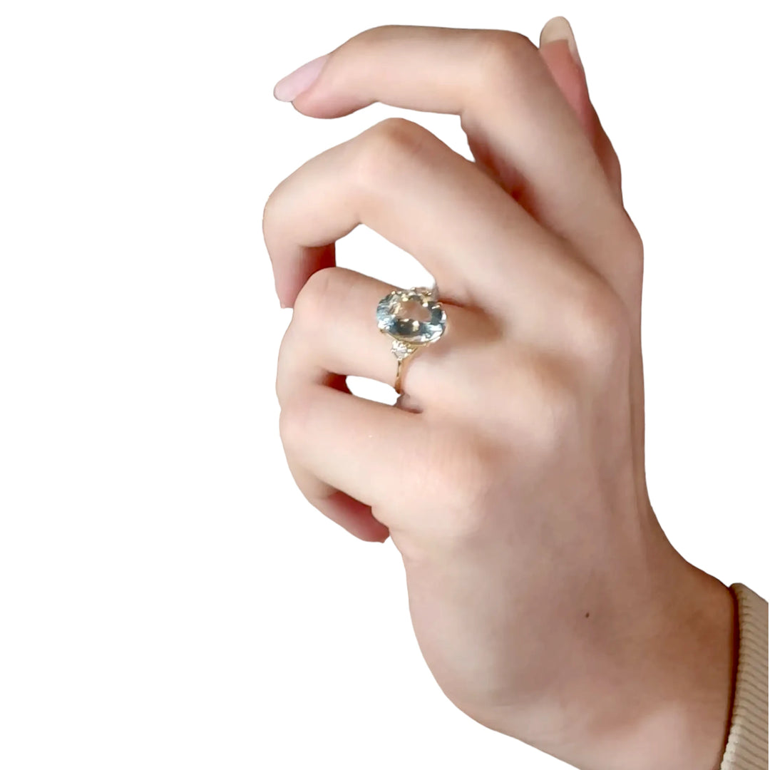  three-stone engagement ring with an oval aquamarine on women hand model 