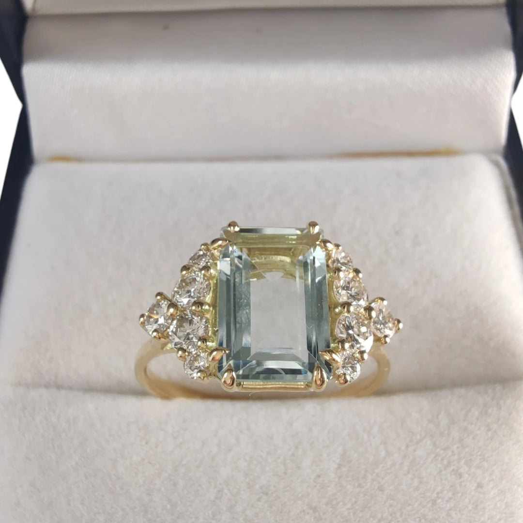 An aquamarine engagement ring in 18K gold with diamonds, presented inside a Christmas gift box, part of the aquamarine collection, ideal for engagements or holidays