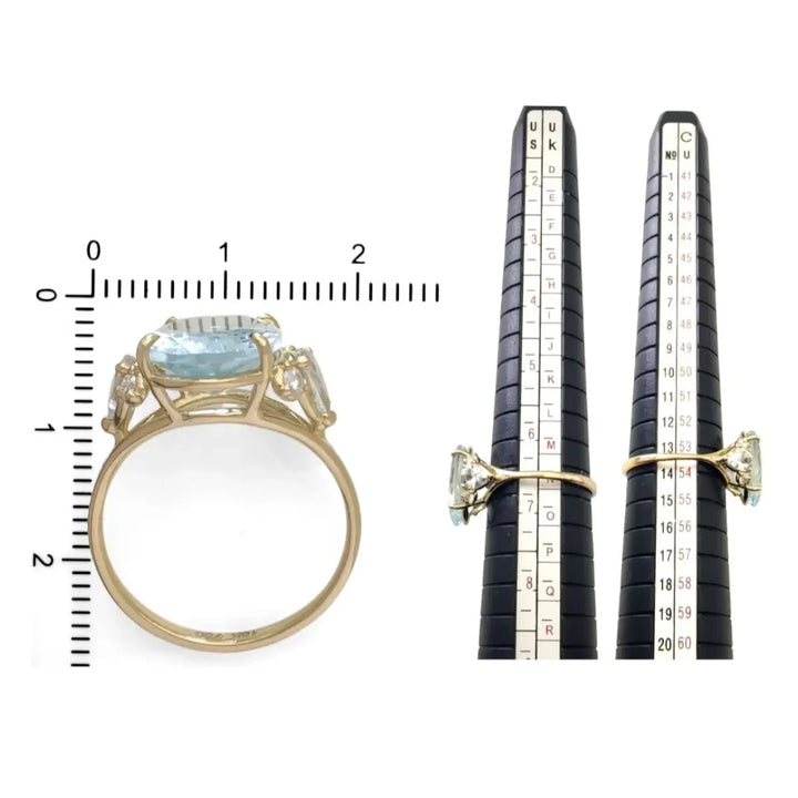 Measurement scale and size chart for a handcrafted engagement ring in 18K yellow gold with an oval aquamarine, pear-shaped aquamarines, and diamonds