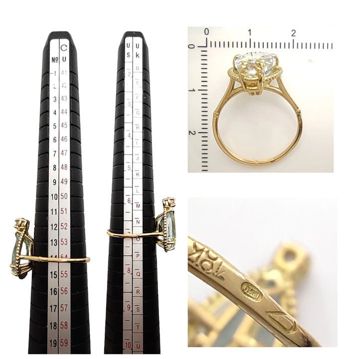 Measurement scale and size chart for a women’s 18K yellow gold pear-cut aquamarine and diamond engagement ring