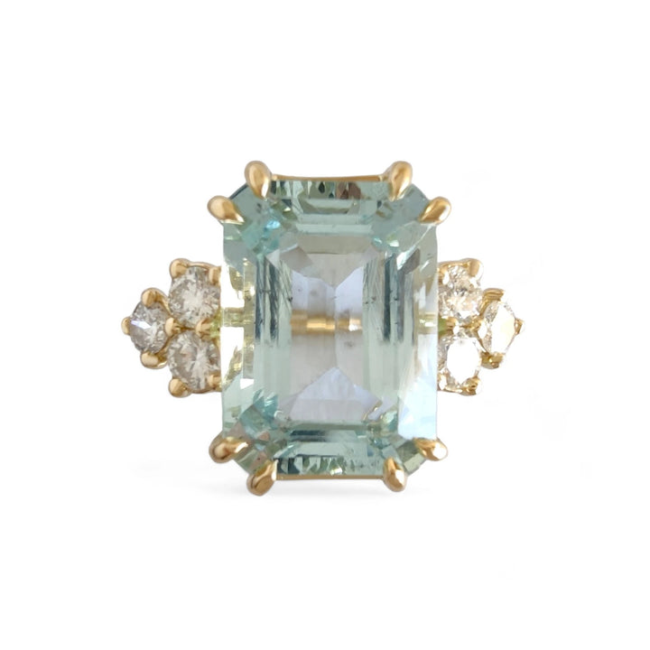 Front view of a handcrafted 18K yellow gold engagement ring featuring a large emerald-cut aquamarine and three diamonds on each side, perfect for a contemporary and stylish proposal or as a lavish Christmas gift