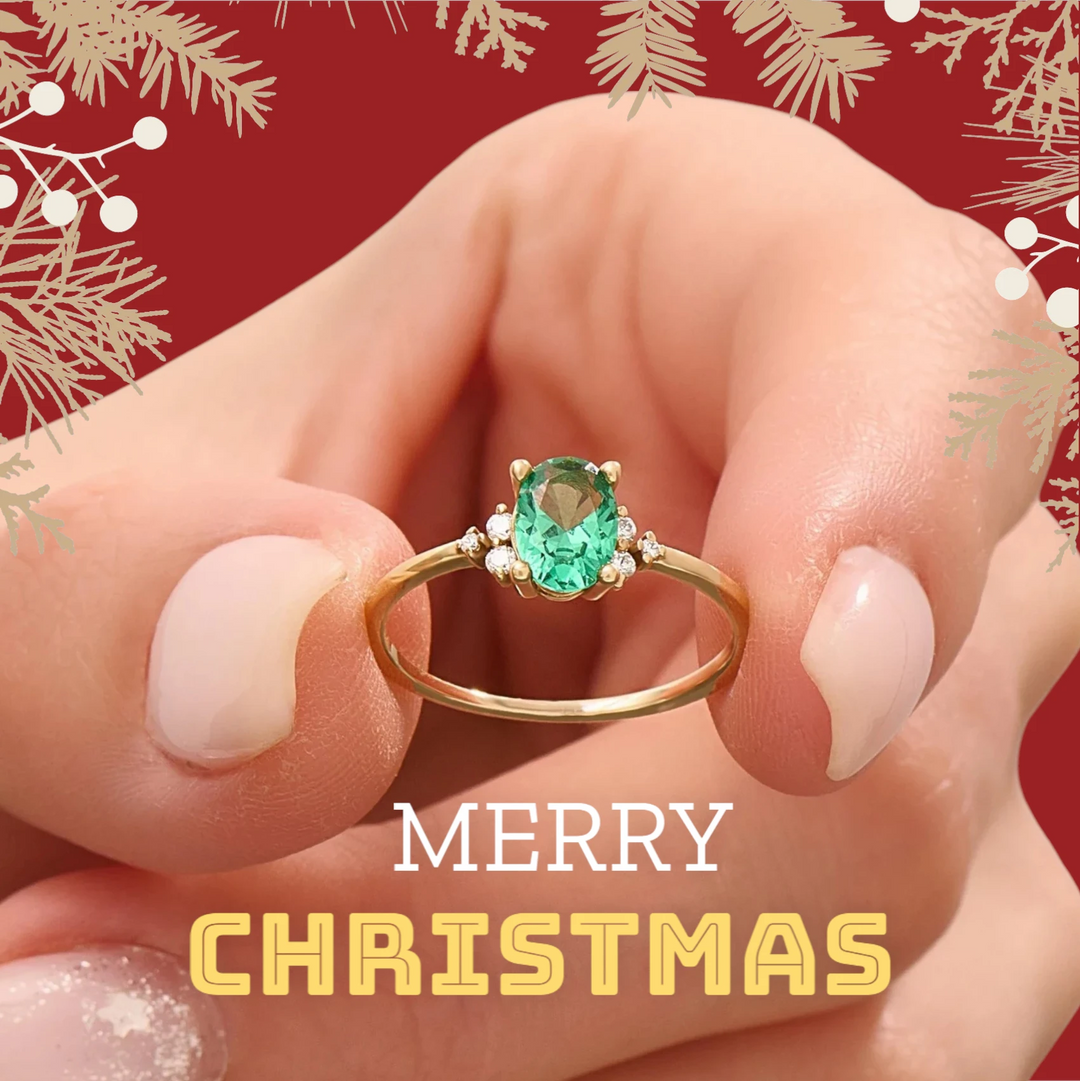 Image of an elegant 18K gold engagement ring featuring an oval-cut emerald center stone flanked by three brilliant diamonds on each side, showcasing timeless luxury and sophistication.