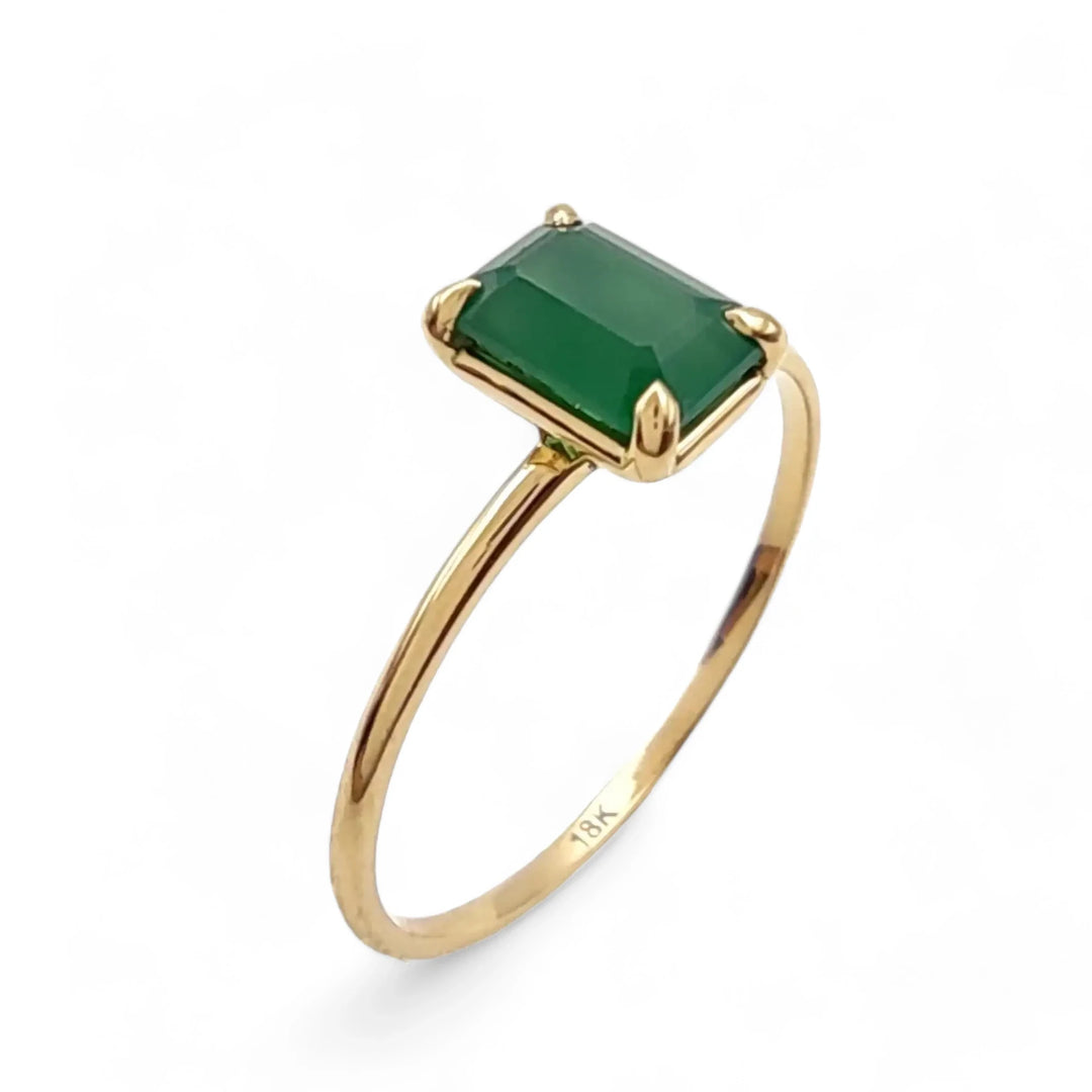 Image of a solitaire emerald engagement ring in 18K yellow gold, perfect for women as a Christmas gift or Black Friday deal, showcasing timeless elegance and luxury