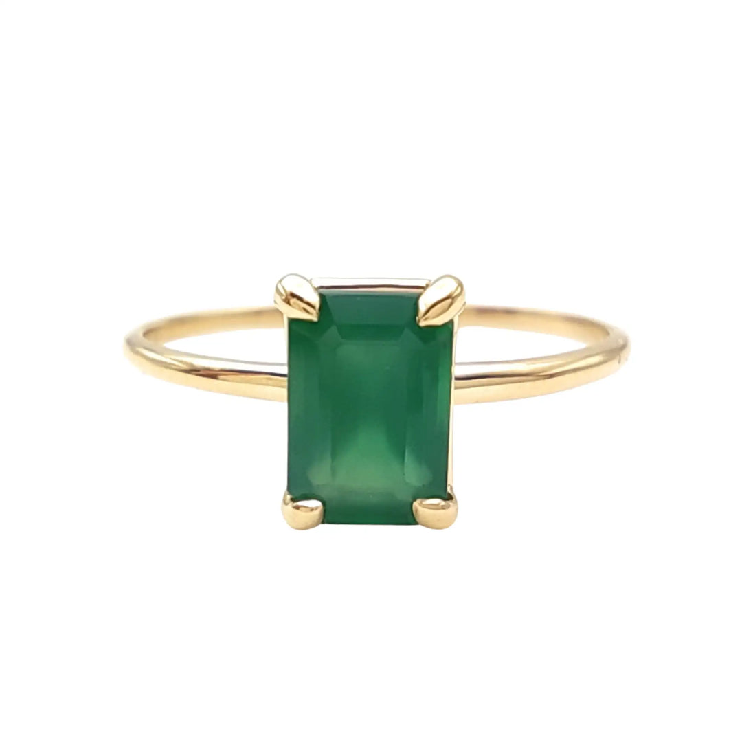 Front view of an 18K yellow gold solitaire emerald engagement ring, emphasizing the clean lines and central gemstone, ideal for proposals or special occasions