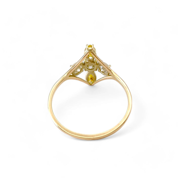 Back view of a 14K yellow gold engagement ring featuring brilliant and fancy yellow marquise diamonds arranged in a cross pattern, emphasizing the ring's intricate design