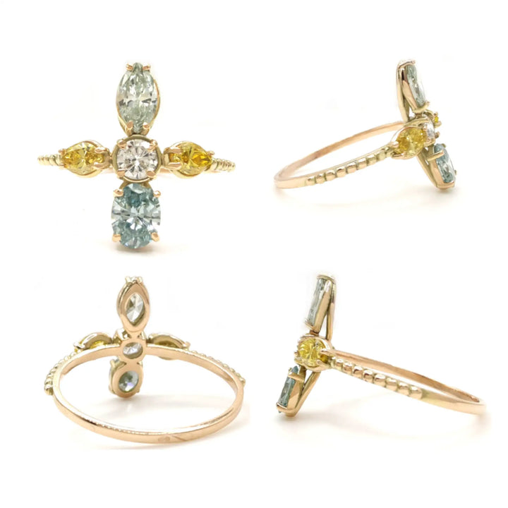 Front, left, rear, and right views of a 14K yellow gold engagement ring displayed in one image, highlighting the cross design with a central brilliant diamond and fancy blue and yellow diamonds, perfect for buyers looking for a statement engagement ring