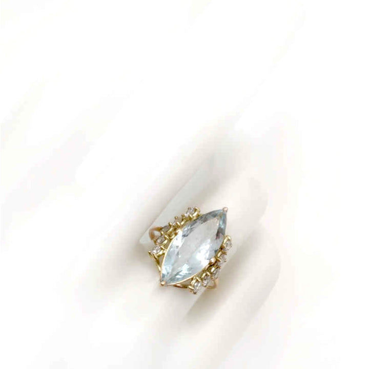 14K yellow gold engagement ring displayed on a mannequin hand, featuring a marquise-cut diamond and five accent diamonds on each side, ideal for a modern and elegant proposal