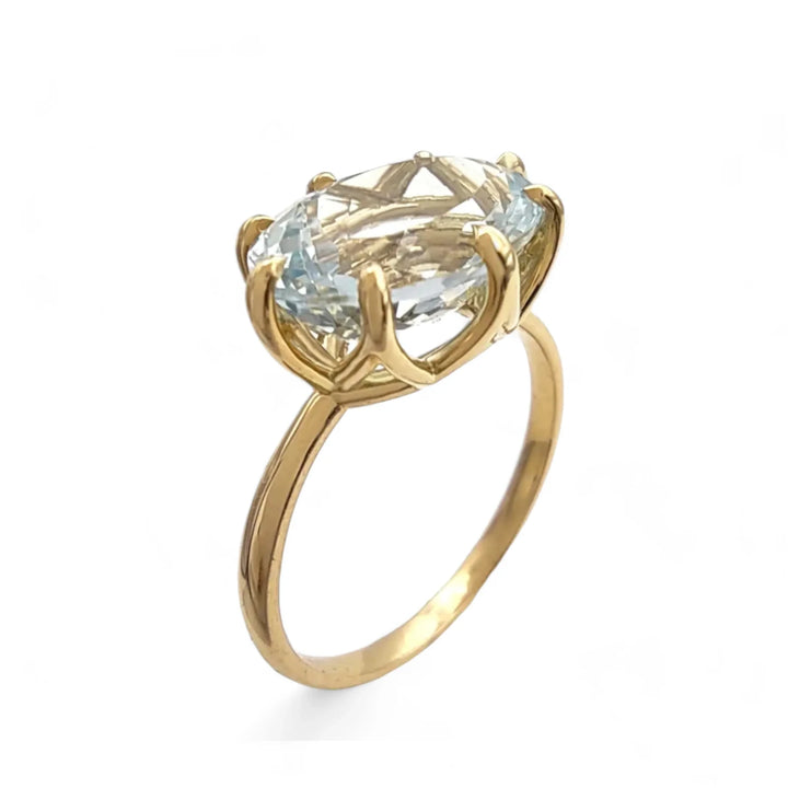 Side vertical view of an 18K yellow gold solitaire engagement ring featuring a central oval aquamarine set in a basket mount, ideal as a birthstone gift for Christmas.