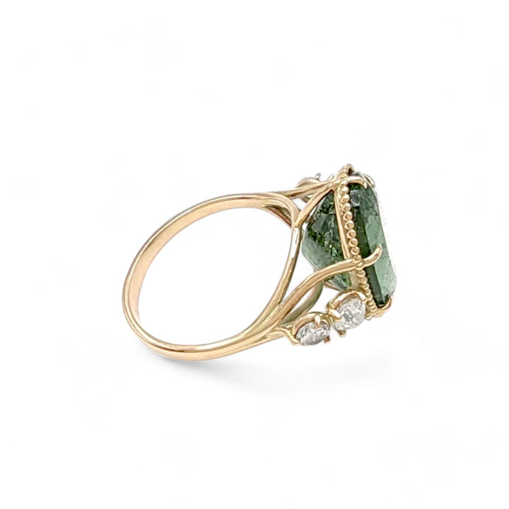 Right side view of a 14K yellow gold cocktail ring featuring an oval green tourmaline and diamonds, perfect for those seeking a unique and certified engagement or cocktail ring