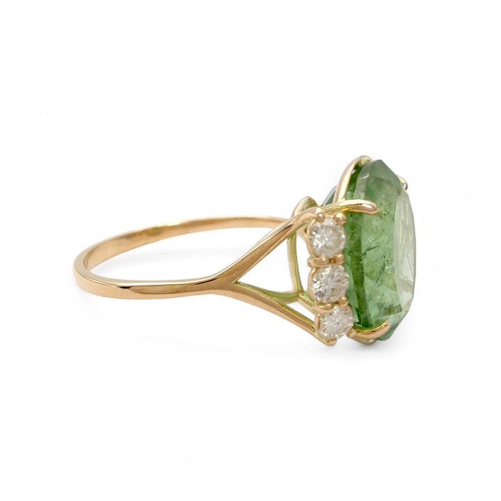 Right side view of a contemporary 14K yellow gold engagement ring featuring an oval green tourmaline and brilliant diamonds, perfect for a sophisticated proposal.