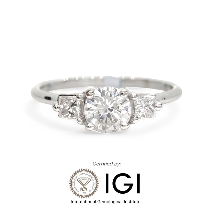 Luxurious white gold engagement ring featuring a stunning round-cut diamond center stone, certified by the International Gemological Institute (IGI). This elegant piece combines beauty and authenticity