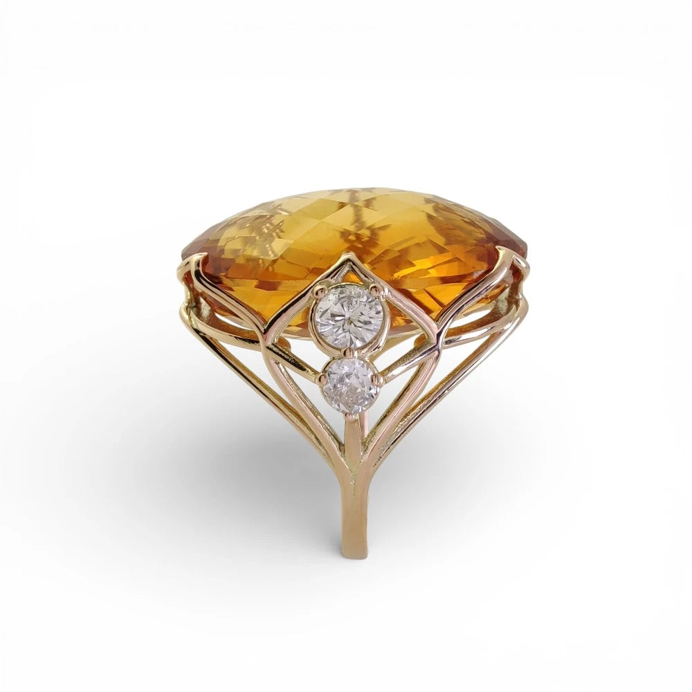 Handcrafted citrine ring in yellow gold showing low profile gemstone and diamond detail in sculptural setting