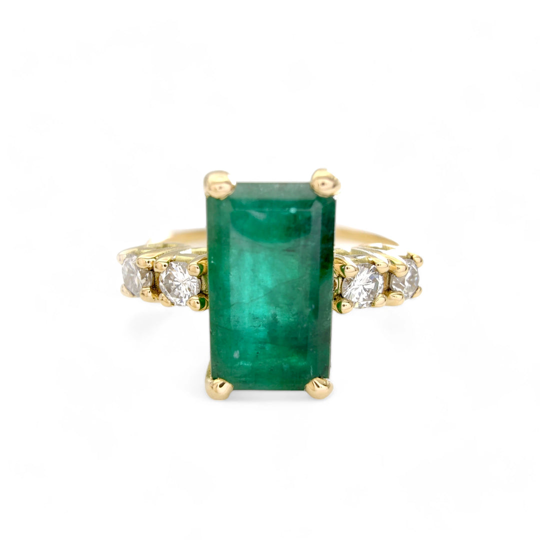 ront view of a timeless 18K yellow gold engagement ring with a central emerald-cut emerald and diamond accents, perfect for proposals or Christmas gifts