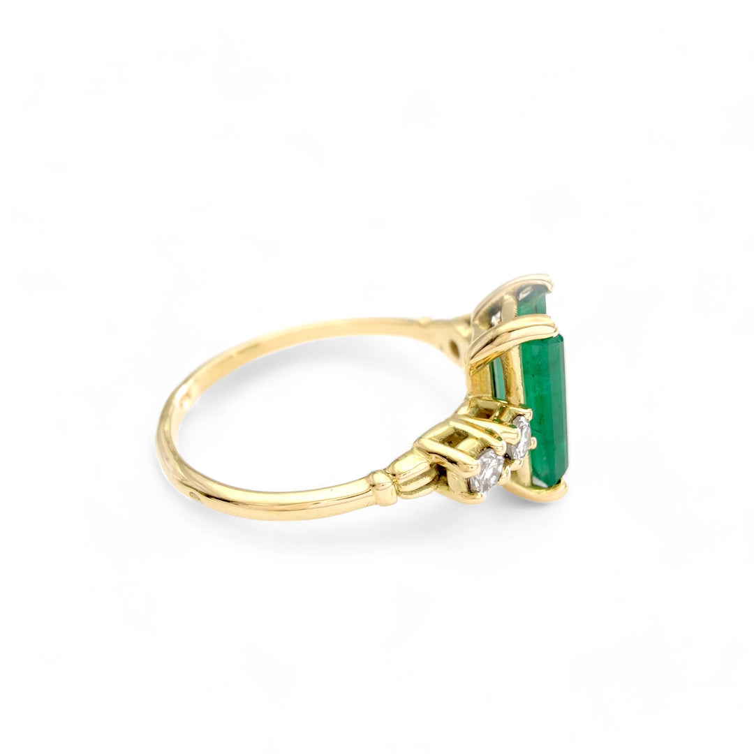 Right horizontal side view of an 18K yellow gold emerald engagement ring with diamond detailing, perfect for women who love vintage-inspired jewelry

