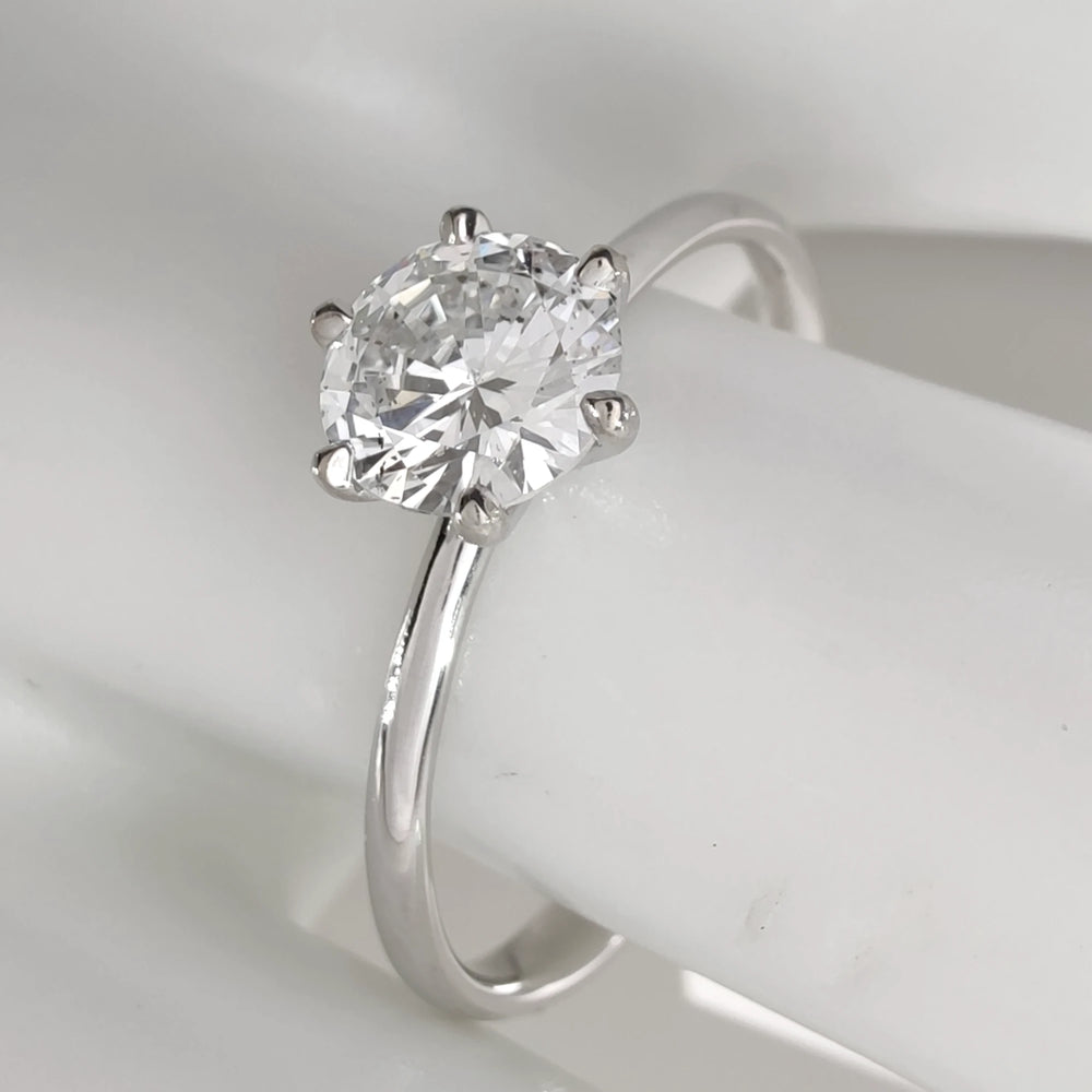 Elegant solitaire ring displayed on mannequin hand for scale and fit preview-engagemet-ring