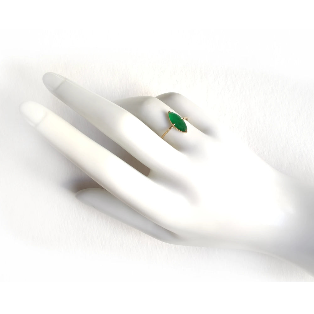Elegant 18K yellow gold solitaire ring with a central marquise emerald and vintage-style band displayed on a mannequin hand