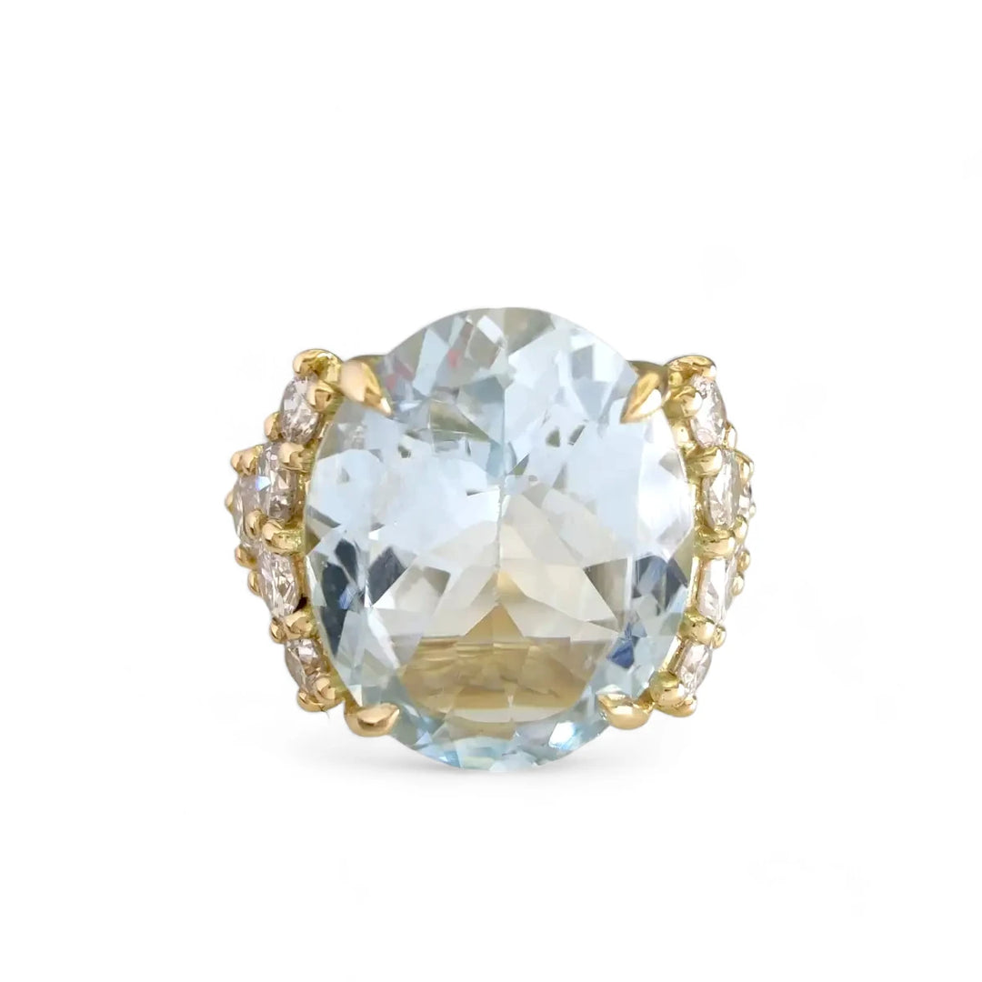 Front view of a new 18K yellow gold engagement ring with a natural oval aquamarine and five brilliant diamonds on each side, a perfect Christmas or proposal gift.