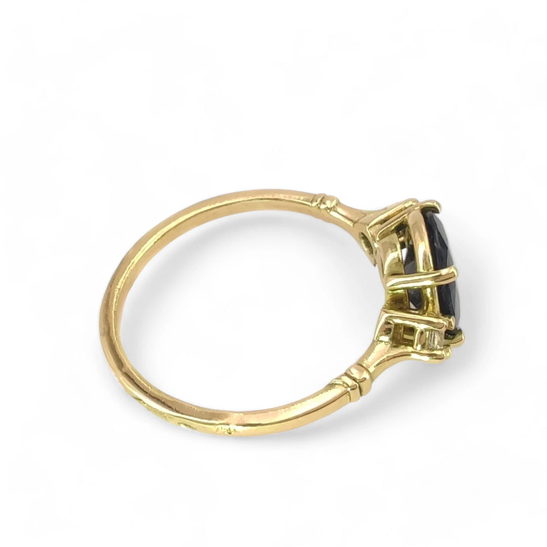 Right side view of a bold sapphire engagement ring in 18K yellow gold with a classic three-stone design