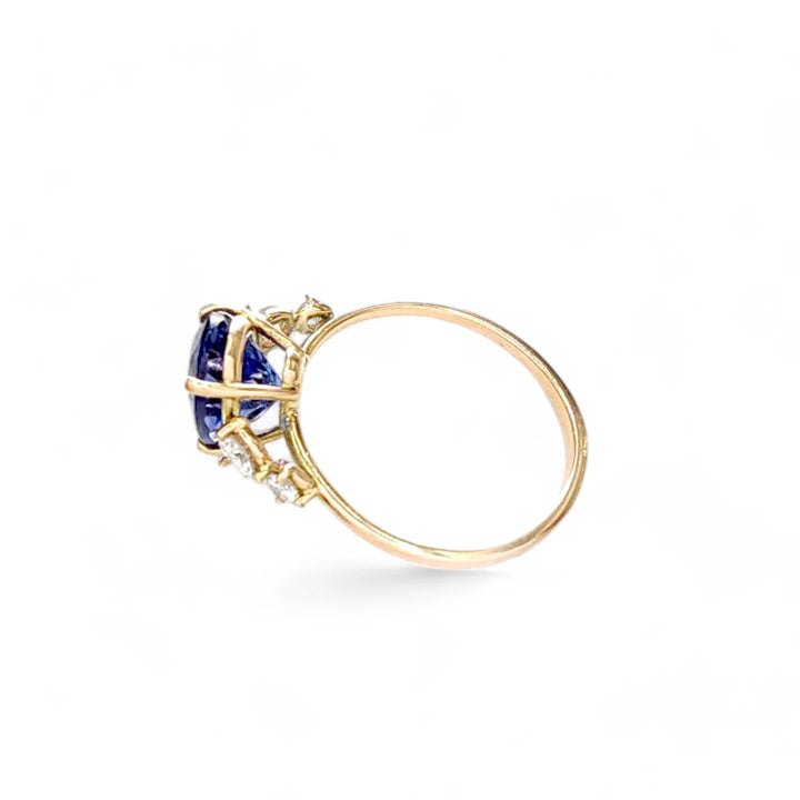 Left side view of a 14K yellow gold Tanzanite ring with diamond accents