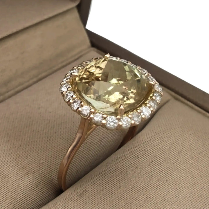  Beautiful 14K yellow gold women’s ring with a yellow Tourmaline and diamond halo elegantly displayed in a jewelry box